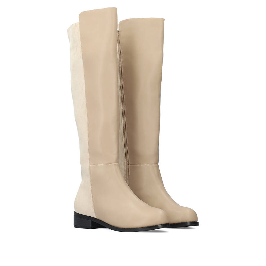 Flat knee-high boots combined in beige colour. 