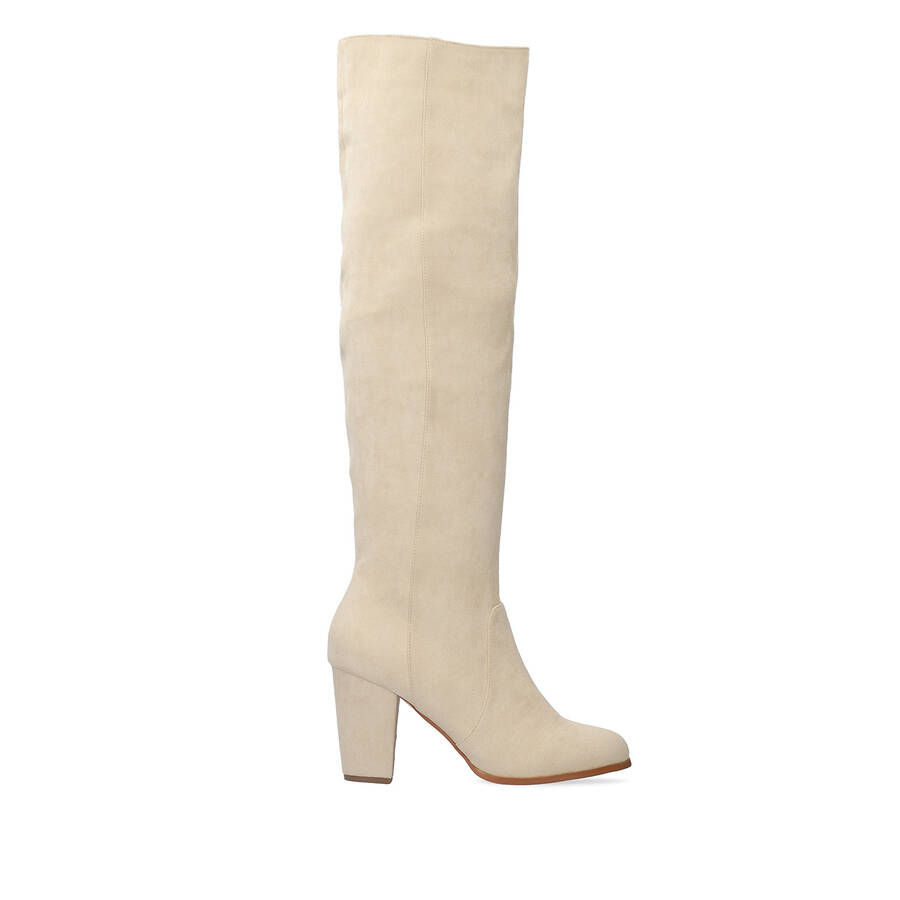 Heeled knee-high boots in off-white faux suede. 