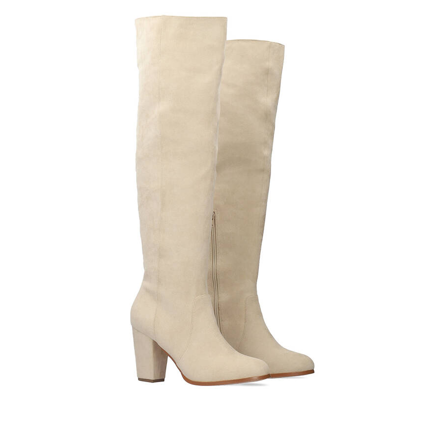 Heeled knee-high boots in off-white faux suede. 