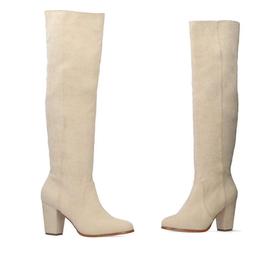 Heeled knee-high boots in off-white faux suede. 