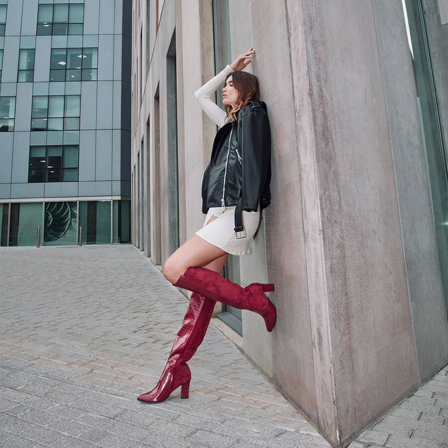 Heeled knee-high boots combined black faux croc leather with faux suede. 