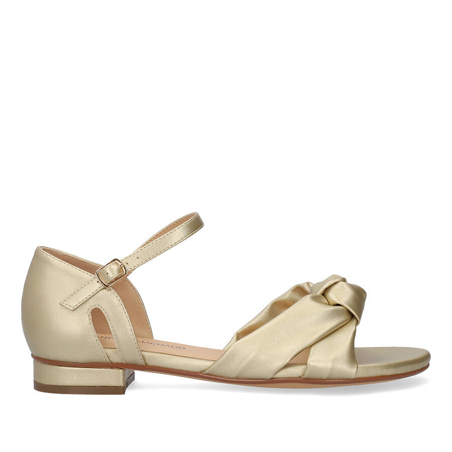 Flat sandals in soft golden colored material 