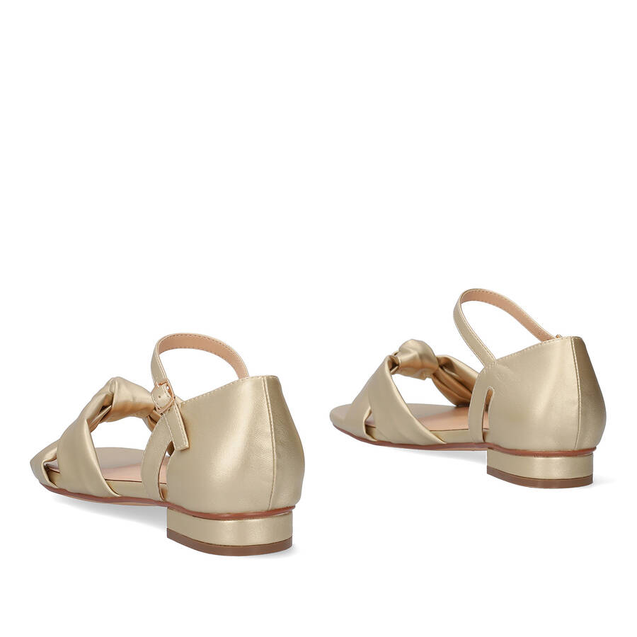 Flat sandals in soft golden colored material 