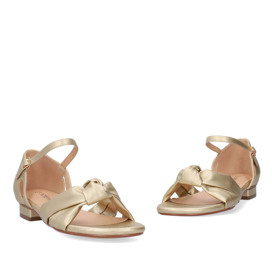 Flat sandals in soft golden colored material 