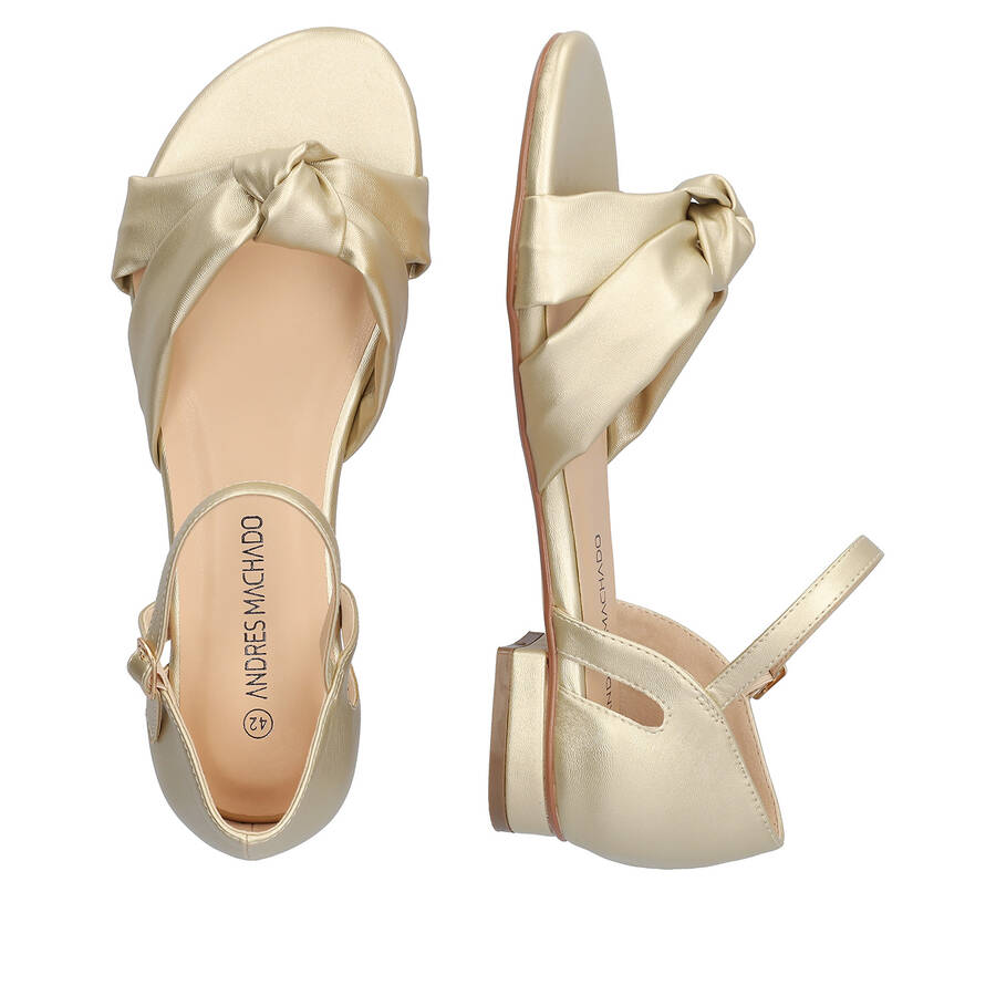 Flat sandals in soft golden colored material 