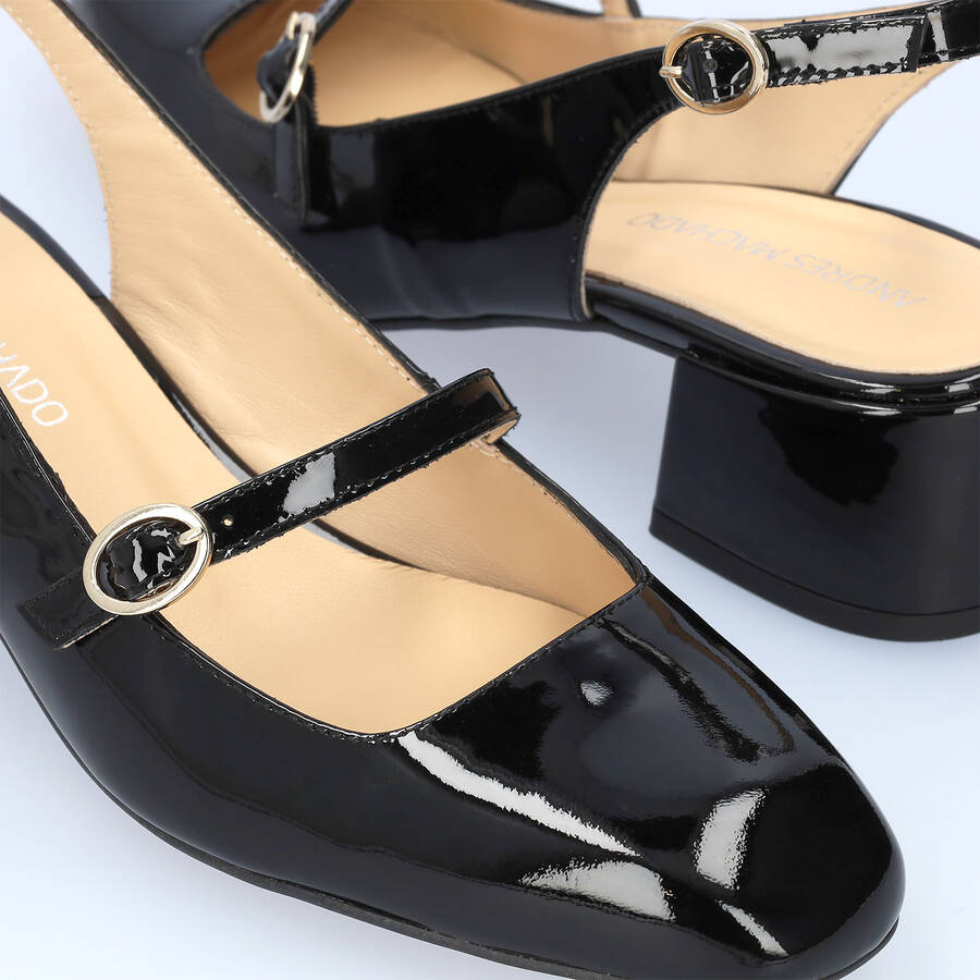 Heeled black patent leather Mary Janes 