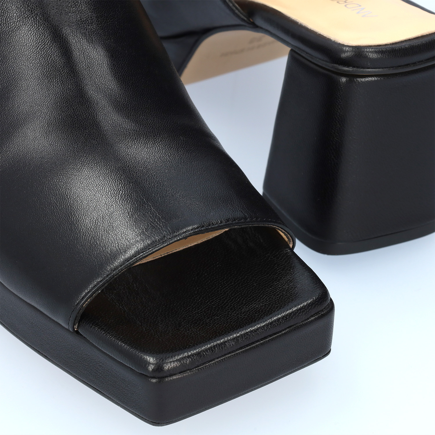 Heeled mules with platform in black leather 