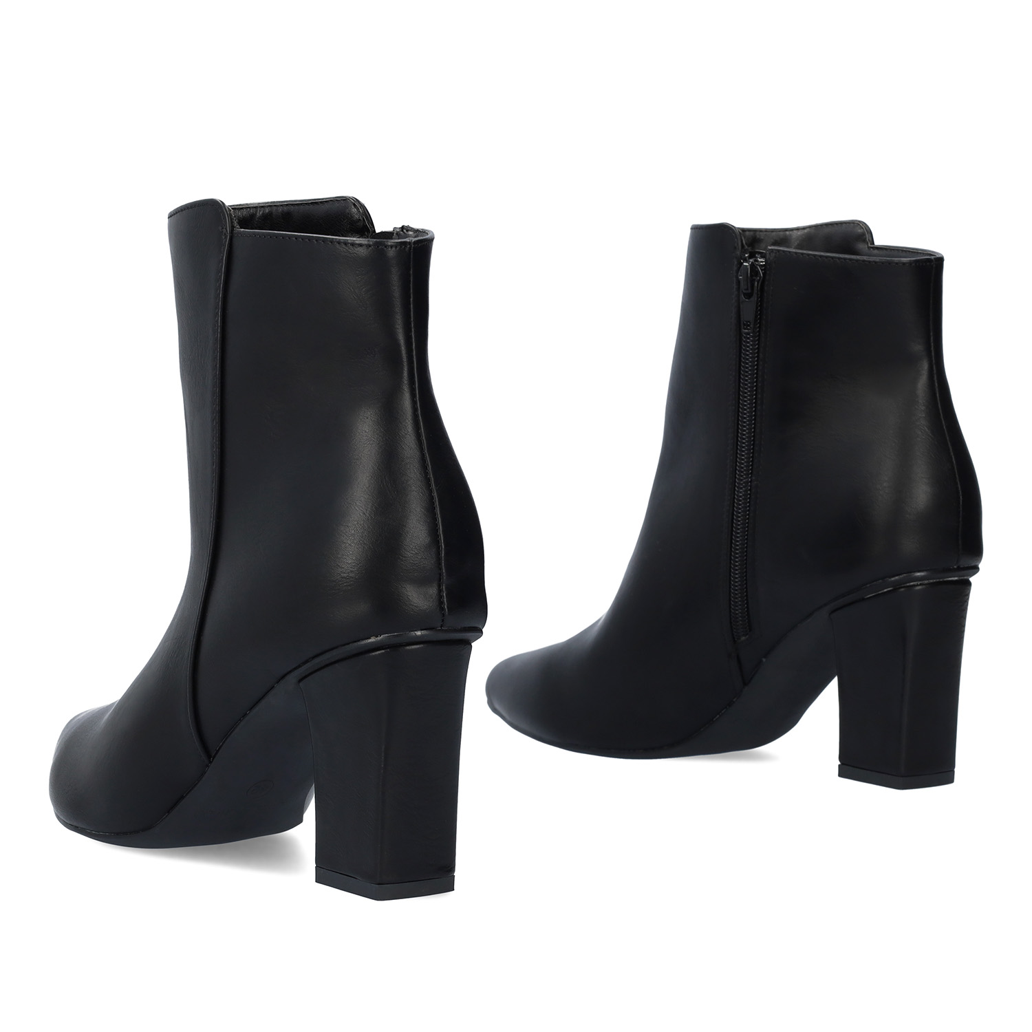 Heeled booties in black faux leather. 