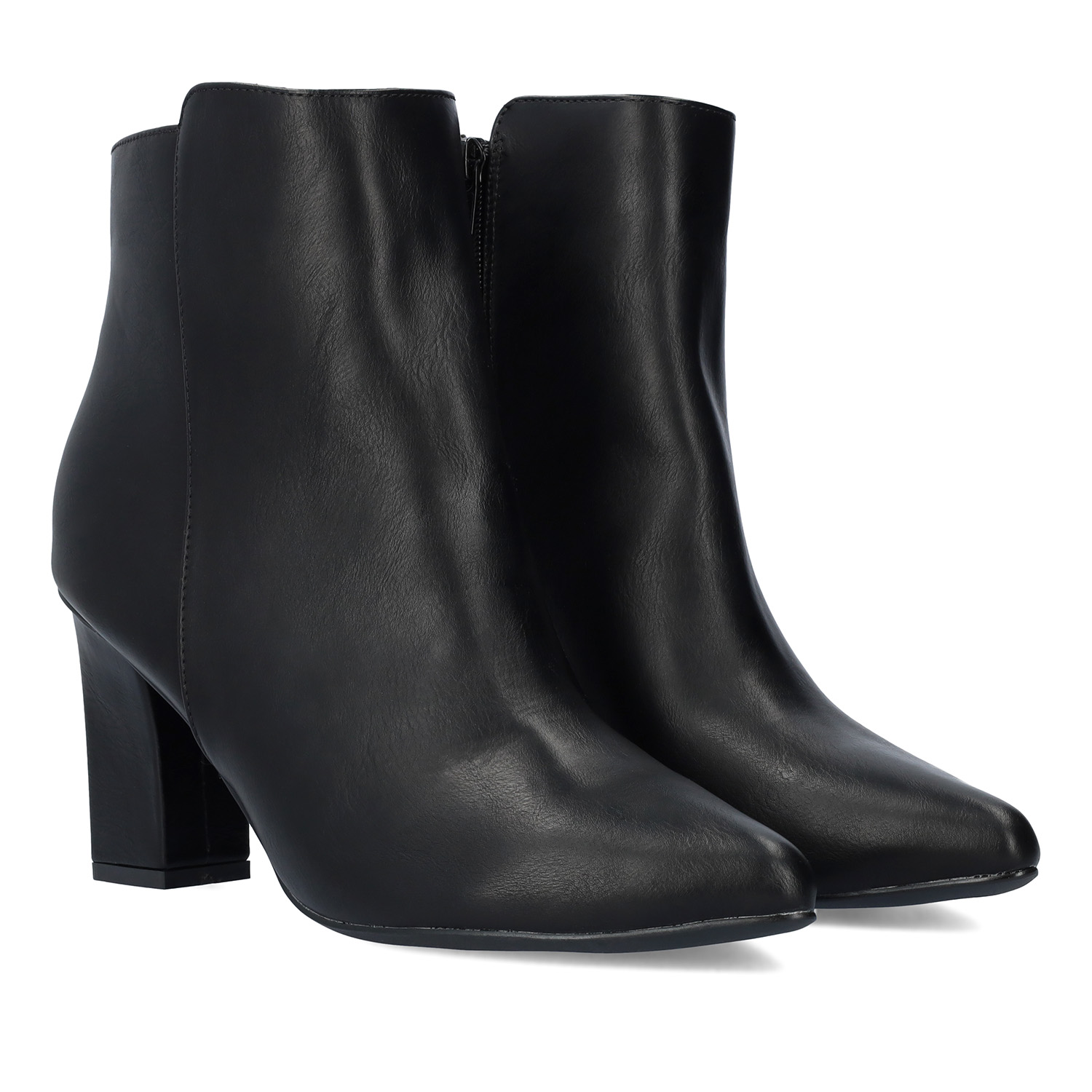 Heeled booties in black faux leather.
